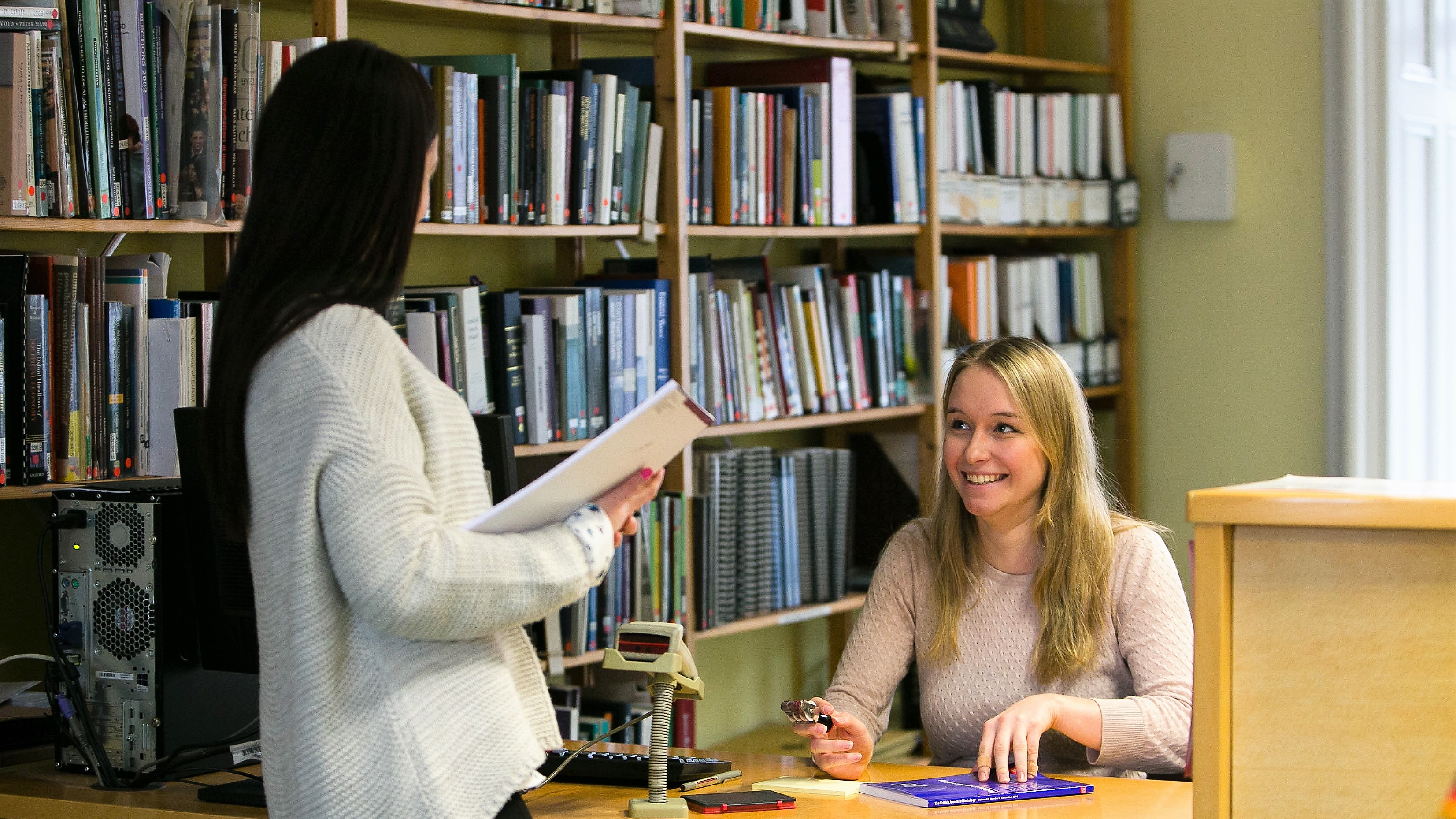 Two girls in a library